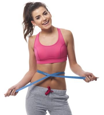 smiling-woman-measuring-her-waist-line-with-tape-measure-min